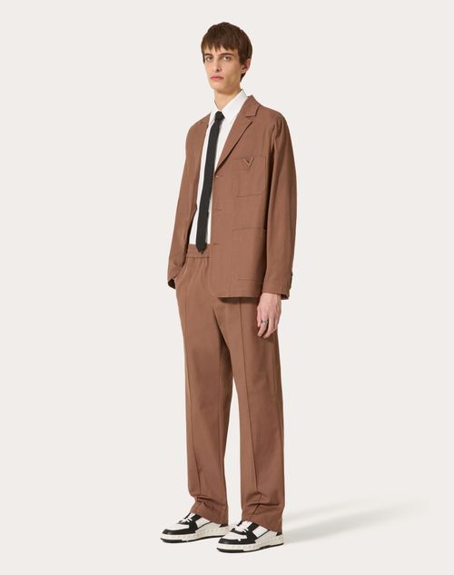 Valentino - Stretch Cotton Canvas Trousers With Rubberised V Detail - Clay - Man - Trousers And Shorts
