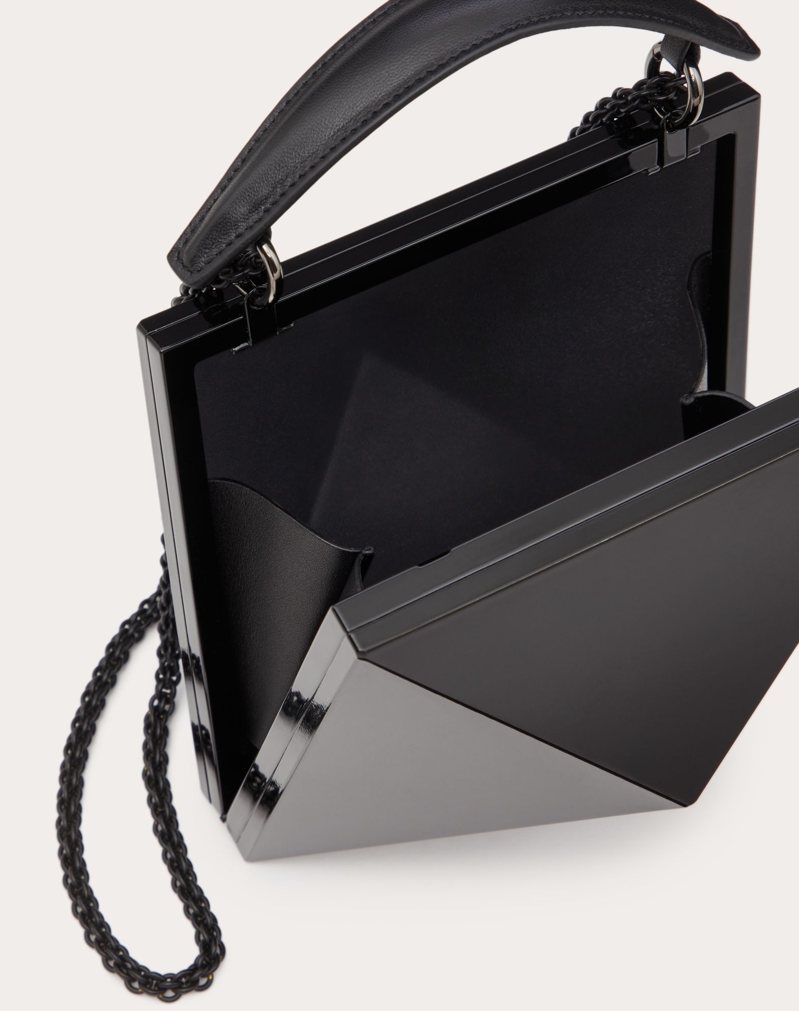 Image of a black Valentino Garavani clutch bag